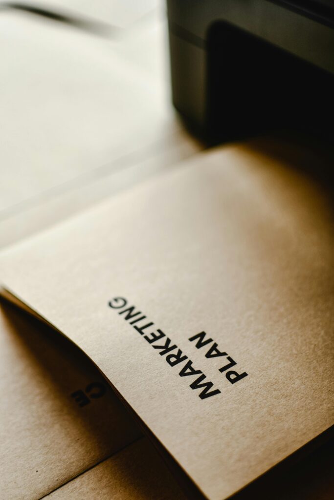 Detailed view of the words 'Marketing Plan' printed on brown paper, conceptual and business themed.